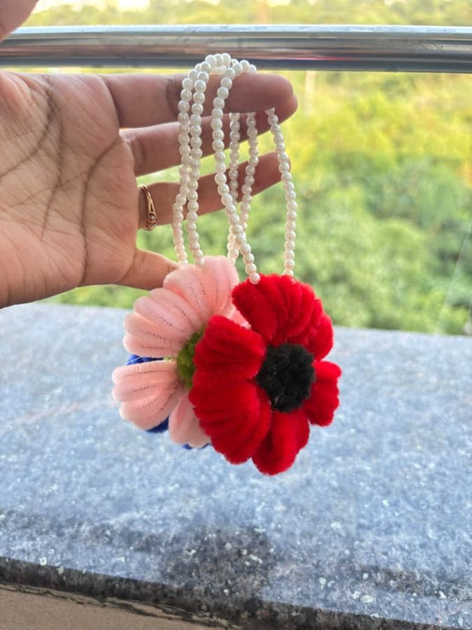 Poppy Pearl Hanging. Handcrafted hanging charm made from soft chenille wire, with red and pink flowers and a pearl bead string. Ideal for car mirrors, bags, or room decor.