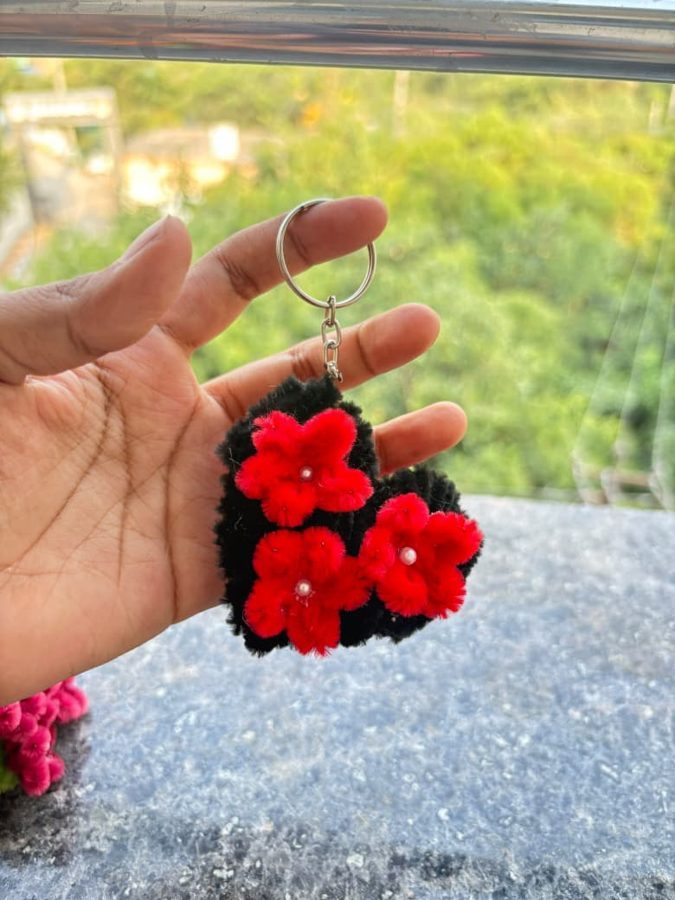 Scarlet Heart Keychain. Handcrafted heart-shaped keychain made from soft chenille wire, with a black base and three red flowers with pearl centers. A cute add-on for keys or bags.